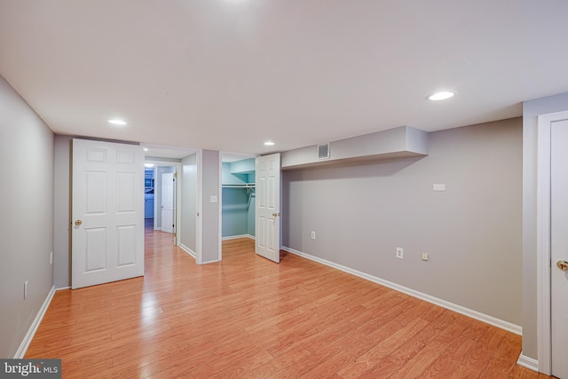 basement with light hardwood / wood-style floors