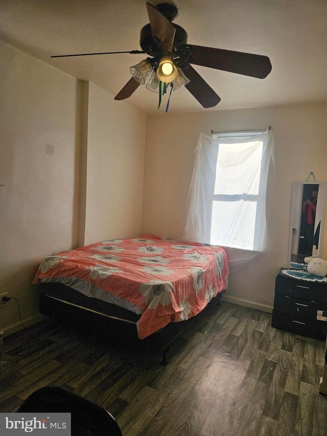 bedroom with ceiling fan and dark hardwood / wood-style floors