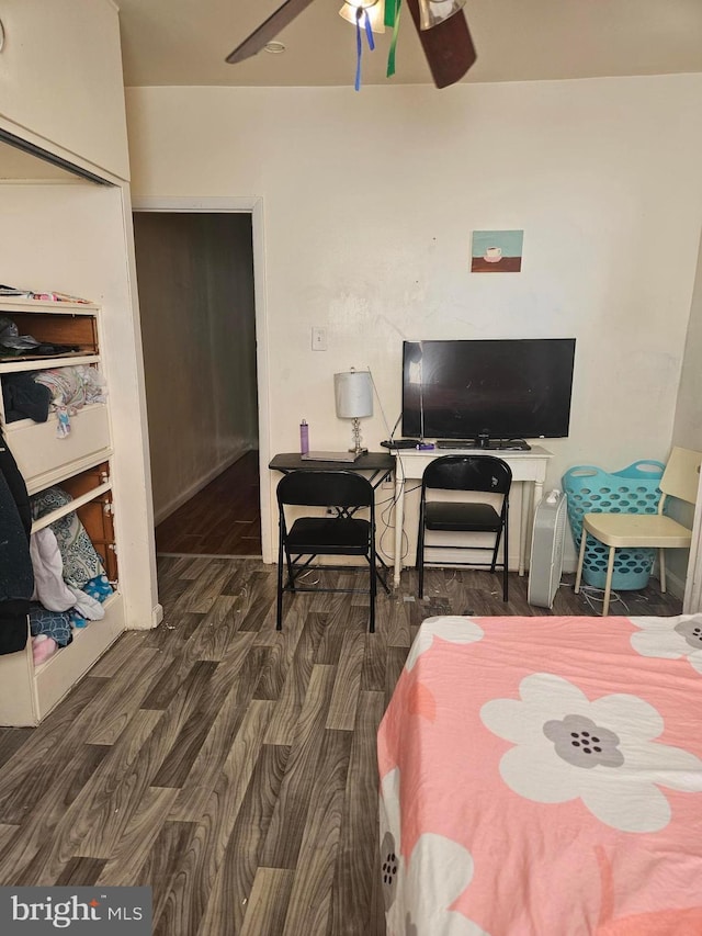 bedroom featuring a closet, dark wood-type flooring, and ceiling fan