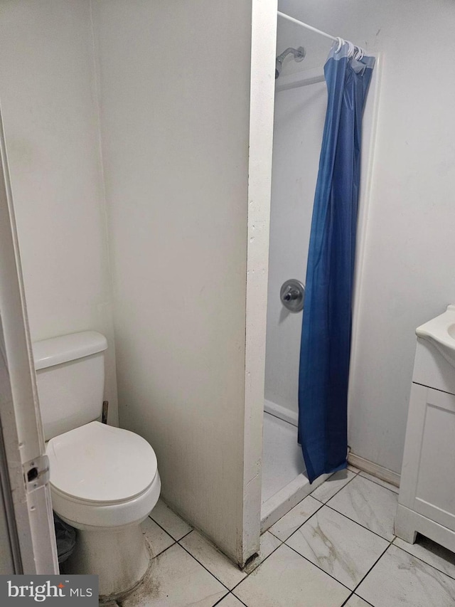 bathroom with toilet and walk in shower