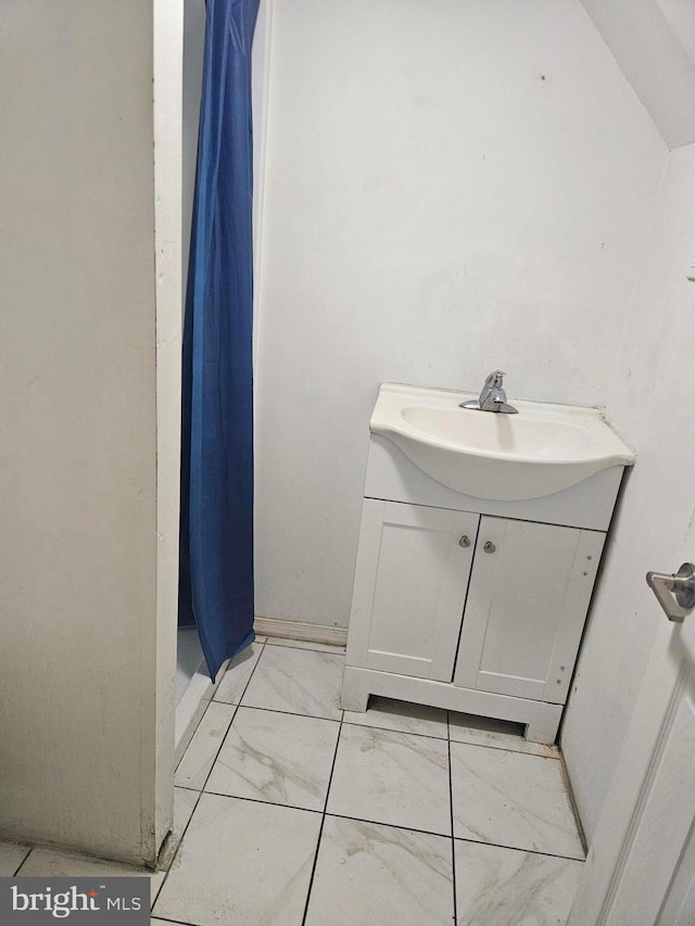 bathroom with vanity and vaulted ceiling