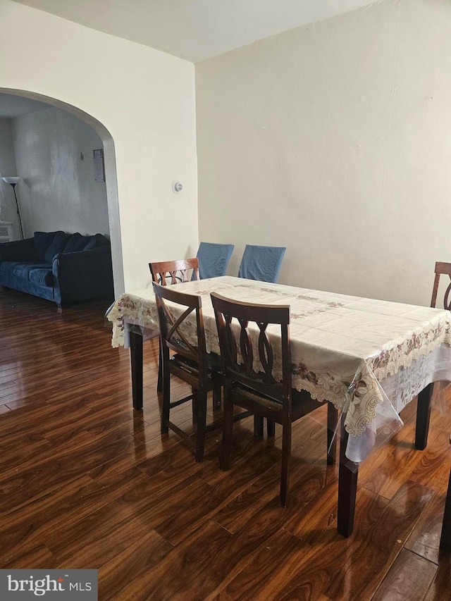 dining area featuring dark wood-type flooring