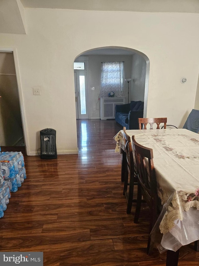 dining area featuring dark wood-type flooring