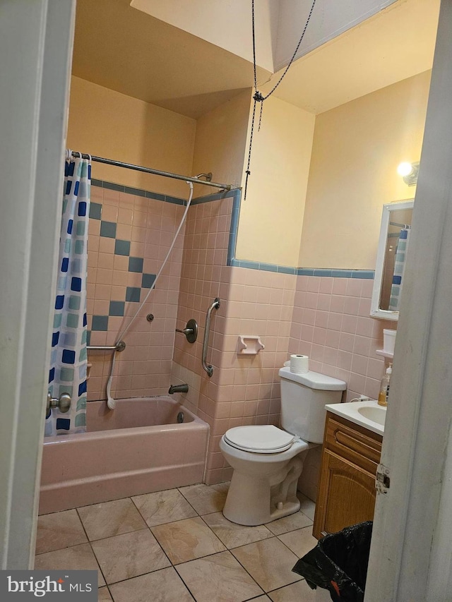 full bathroom with vanity, tile patterned floors, toilet, shower / bathtub combination with curtain, and tile walls