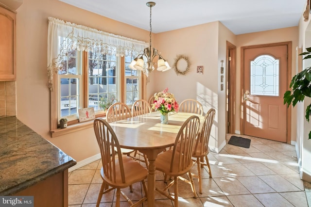 dining room with an inviting chandelier and light tile patterned flooring