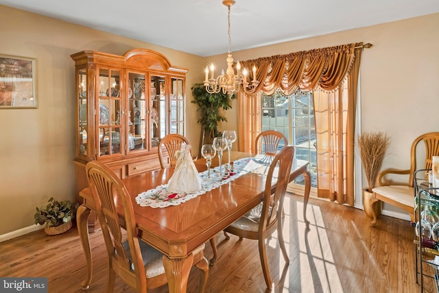 dining room with an inviting chandelier and light hardwood / wood-style floors