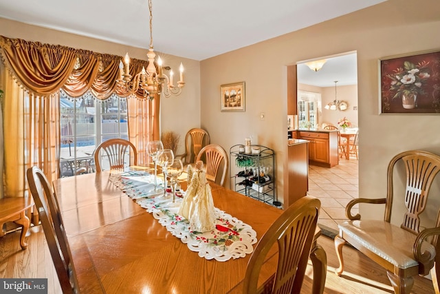 dining room featuring light tile patterned flooring and a chandelier