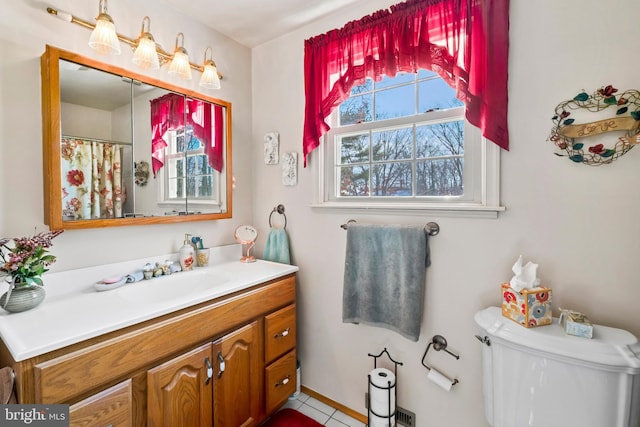 bathroom featuring toilet, tile patterned flooring, and vanity