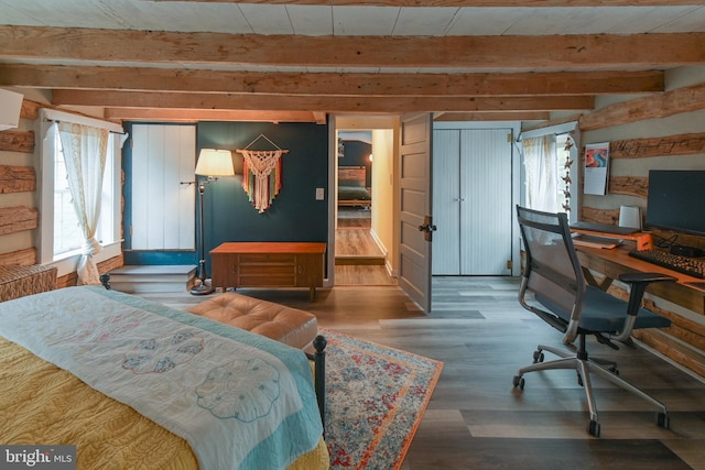 bedroom with multiple windows, beamed ceiling, and wood finished floors