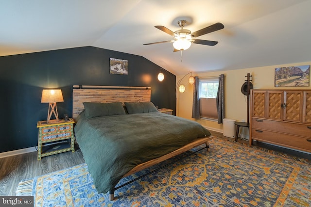 bedroom featuring ceiling fan, vaulted ceiling, baseboards, and wood finished floors