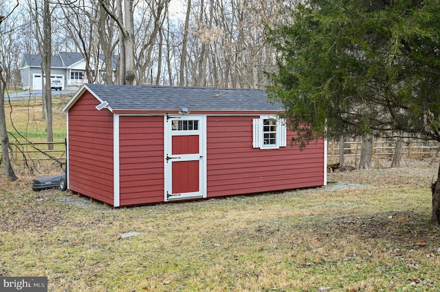 view of shed featuring fence