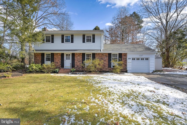 view of front of house featuring a yard and a garage