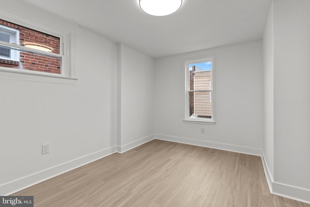 spare room with light hardwood / wood-style flooring