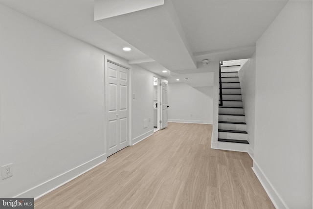 basement with light hardwood / wood-style floors