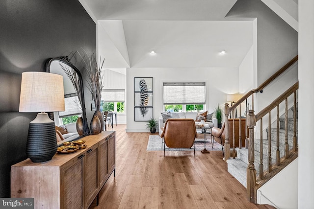 entryway with light hardwood / wood-style floors and vaulted ceiling