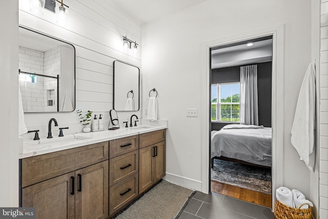 bathroom featuring tile patterned flooring, vanity, and a shower with shower door