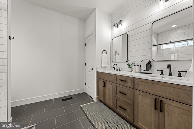 bathroom with tile patterned flooring, vanity, and a shower with door