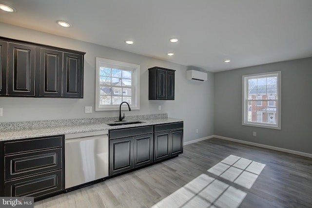 kitchen with an AC wall unit, dishwasher, plenty of natural light, and sink