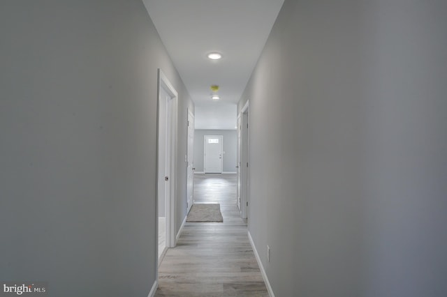 corridor with light hardwood / wood-style flooring