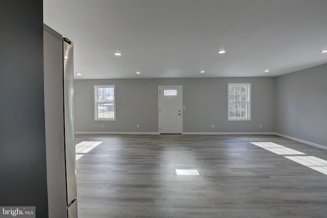 unfurnished room with light wood-type flooring