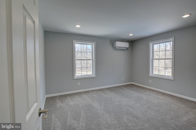 unfurnished room with carpet and a wall mounted air conditioner