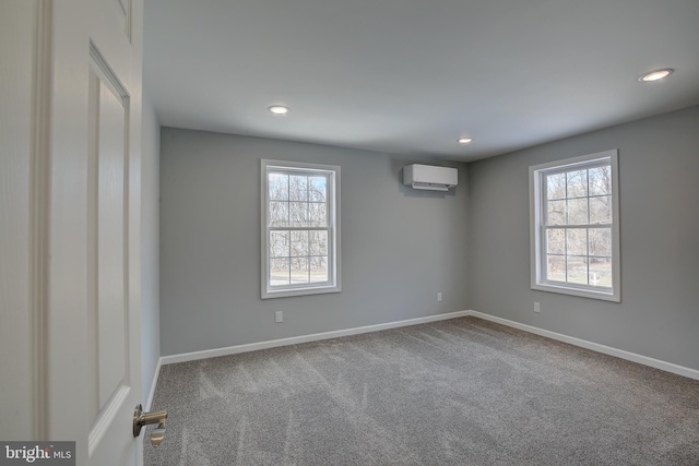 empty room featuring carpet flooring and a wall mounted AC