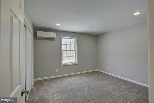 unfurnished bedroom with carpet and a wall mounted air conditioner