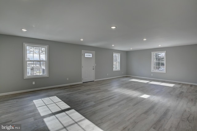 spare room with light hardwood / wood-style floors and a wealth of natural light