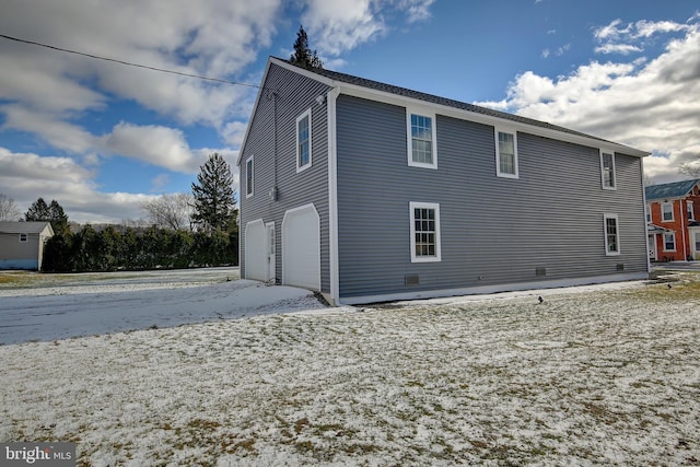 back of property with a garage