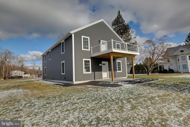 view of front facade with a front yard, a patio, and a deck