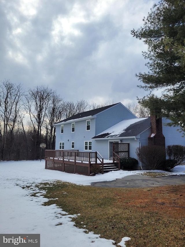 snow covered property featuring a wooden deck