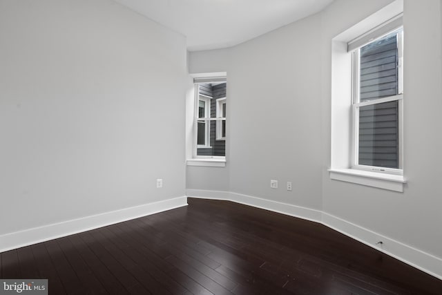 empty room with hardwood / wood-style floors