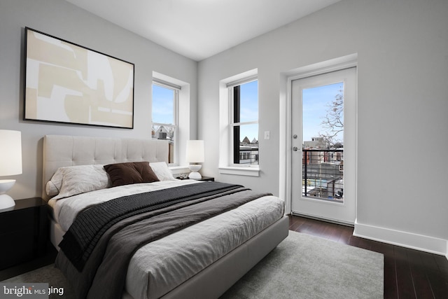 bedroom featuring dark wood-type flooring and access to exterior