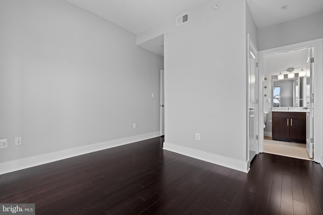 spare room with dark hardwood / wood-style flooring