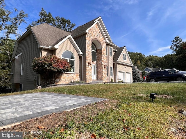 front facade featuring a front lawn and a garage