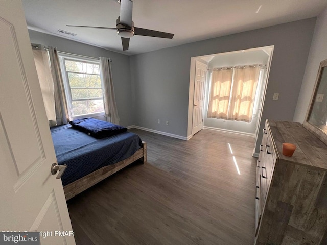 bedroom with ceiling fan and dark hardwood / wood-style flooring