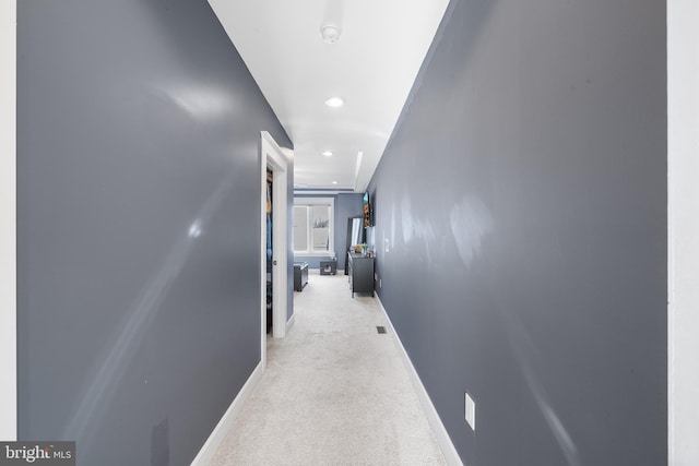 hallway with light colored carpet