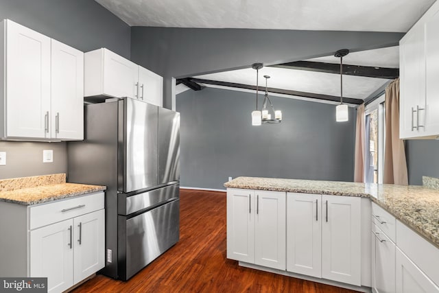 kitchen featuring stainless steel refrigerator, hanging light fixtures, lofted ceiling with beams, light stone counters, and white cabinets