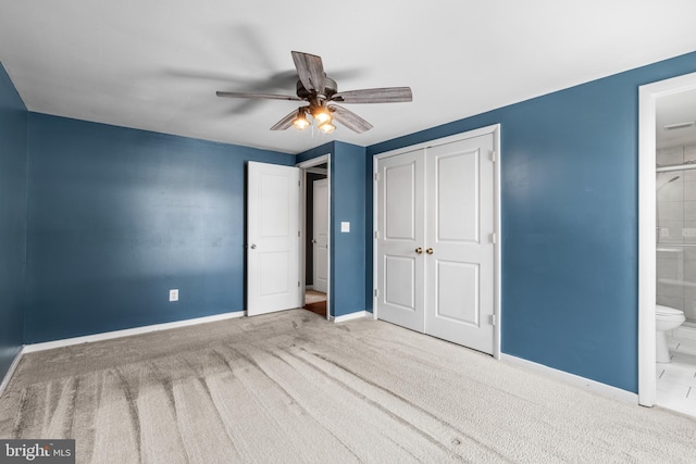 unfurnished bedroom with ceiling fan, connected bathroom, a closet, and carpet floors