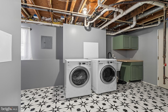 laundry area featuring washer and clothes dryer, electric panel, and cabinets