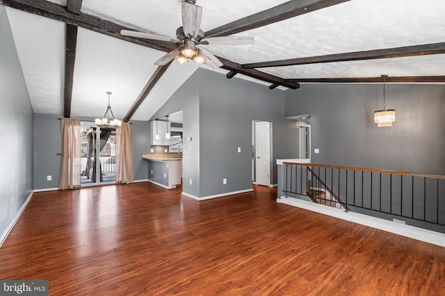 unfurnished living room with ceiling fan with notable chandelier, wood-type flooring, a textured ceiling, and vaulted ceiling with beams