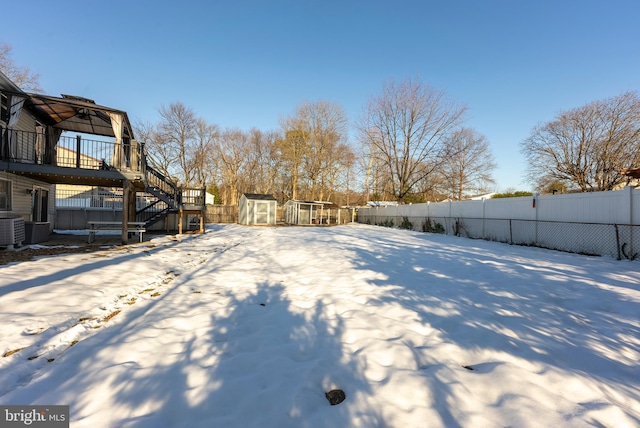 yard covered in snow featuring cooling unit