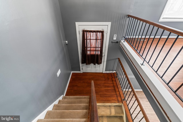 stairs featuring hardwood / wood-style floors