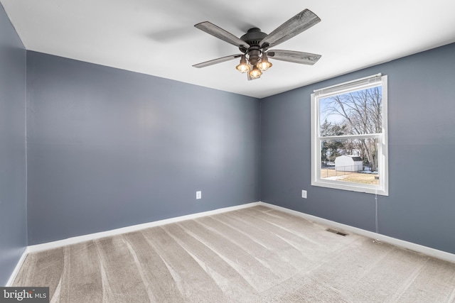 unfurnished room featuring light colored carpet and ceiling fan