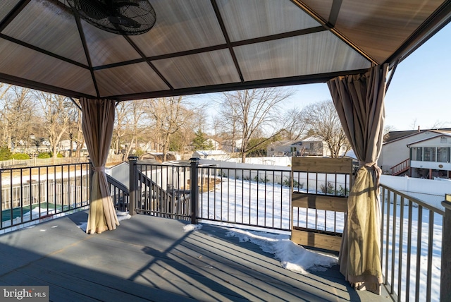 snow covered deck with a gazebo and ceiling fan