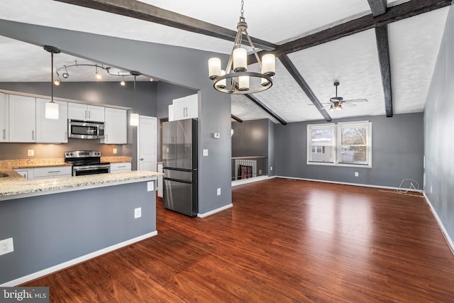 kitchen featuring ceiling fan with notable chandelier, white cabinets, appliances with stainless steel finishes, and hanging light fixtures