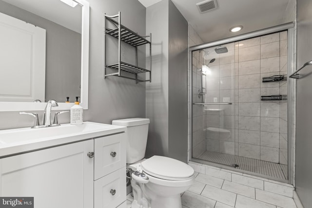 bathroom with an enclosed shower, vanity, and toilet