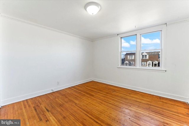 unfurnished room with hardwood / wood-style flooring