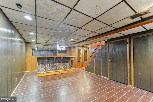 basement featuring wooden walls