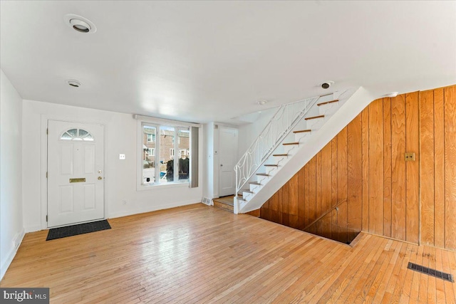 foyer with wooden walls and hardwood / wood-style flooring